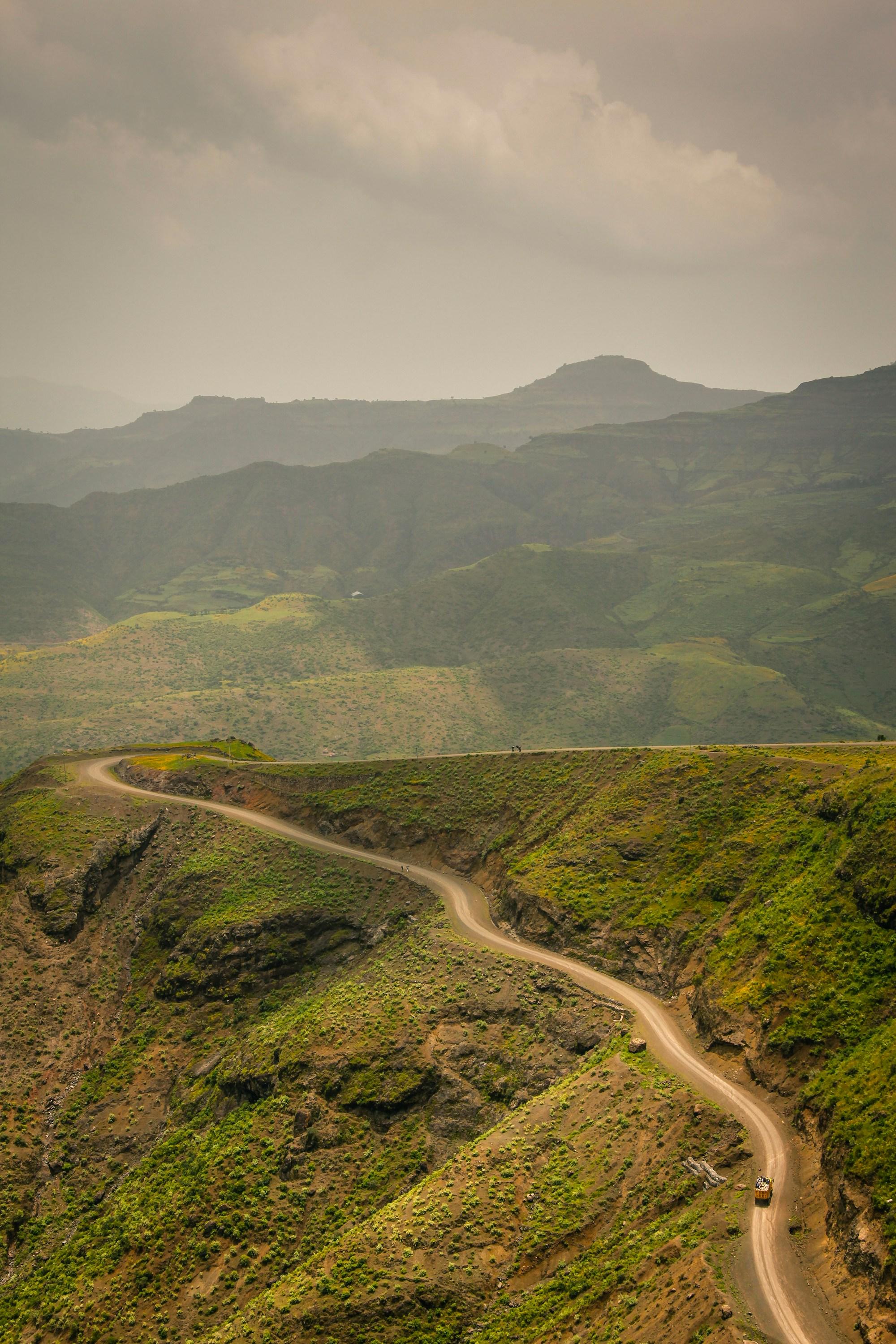 A winding highland road through green Ethiopian mountains